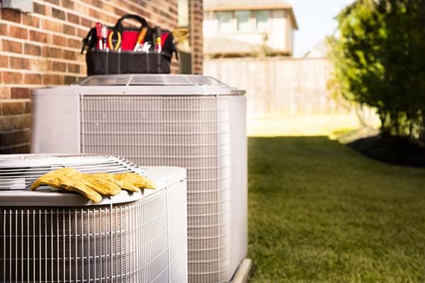 HVAC technician tools and outdoor AC units ready for repair service